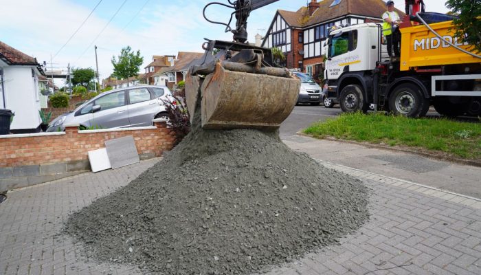 A Middleton Tipper Services grab hire truck delivering aggregates on a residential street.